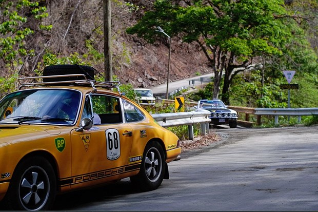 Classic car enthusiasts between dream beaches and high mountains